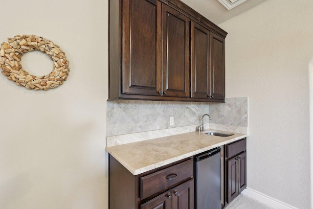 190 Estrella Xing, Georgetown, TX 78628 - kitchen with a sink, dark brown cabinets, decorative backsplash, and light countertops