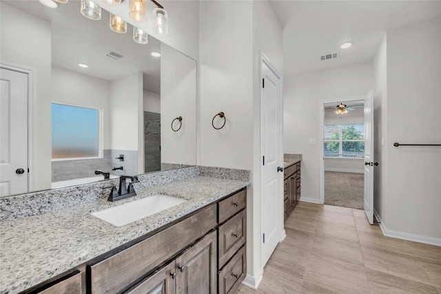 bathroom featuring vanity, baseboards, a ceiling fan, and visible vents