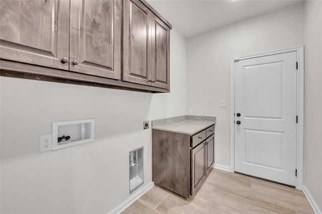 laundry room featuring baseboards, hookup for a washing machine, cabinet space, and electric dryer hookup