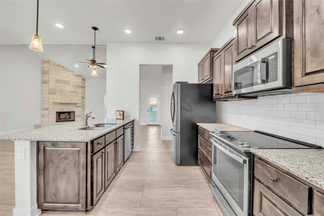 kitchen with ceiling fan, visible vents, a sink, backsplash, and appliances with stainless steel finishes