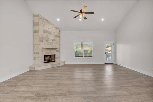 unfurnished living room with high vaulted ceiling, recessed lighting, a fireplace, ceiling fan, and baseboards