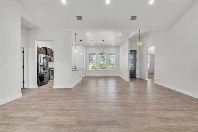 unfurnished living room with recessed lighting and visible vents