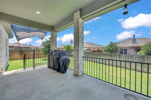 view of patio featuring a grill, a fenced backyard, and a residential view