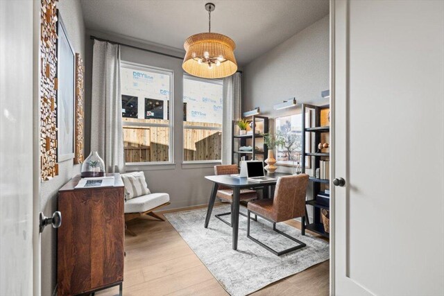 2108 Tobiano Trce, Georgetown, TX 78633 - home office with wood finished floors and a chandelier