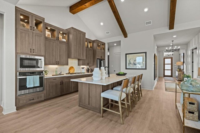 2108 Tobiano Trce, Georgetown, TX 78633 - kitchen with stainless steel appliances, light countertops, light wood-type flooring, backsplash, and recessed lighting