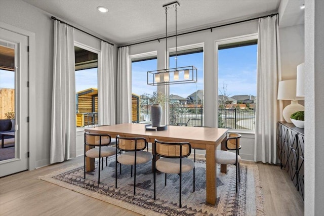 2108 Tobiano Trce, Georgetown, TX 78633 - dining space with light wood-style floors, a desk, and recessed lighting