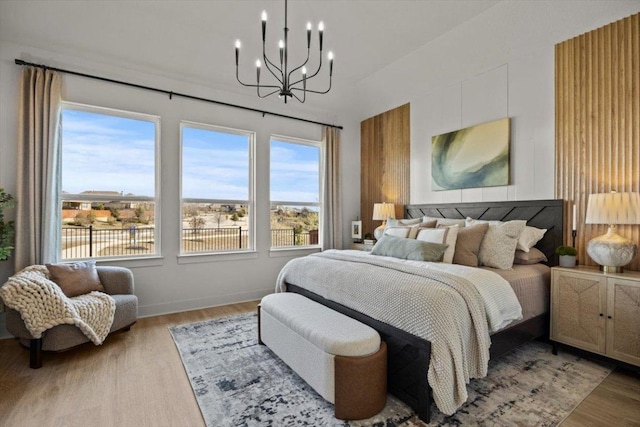 2108 Tobiano Trce, Georgetown, TX 78633 - bedroom featuring a chandelier and light wood-style flooring