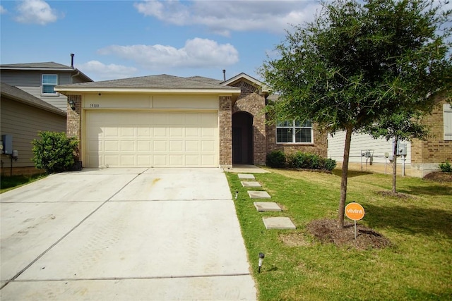 view of front of property with brick siding, a front lawn, driveway, and an attached garage