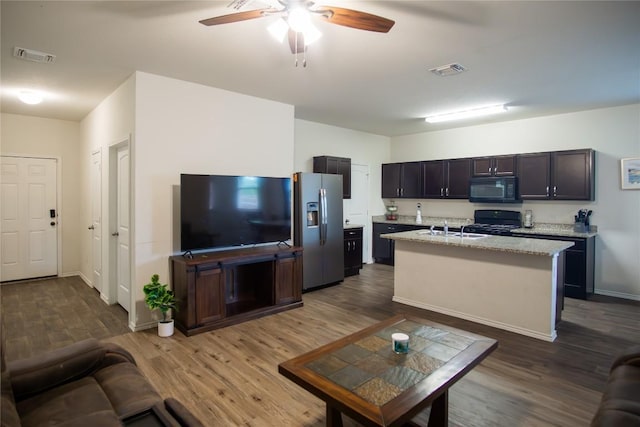 living area with dark wood finished floors, ceiling fan, baseboards, and visible vents