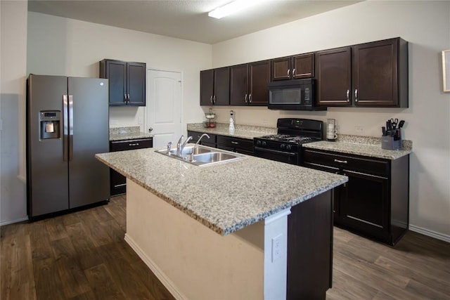 kitchen with dark brown cabinets, a sink, dark wood-type flooring, and black appliances