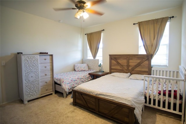bedroom featuring light carpet and ceiling fan