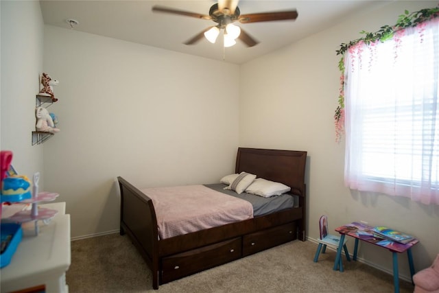 carpeted bedroom featuring ceiling fan and multiple windows