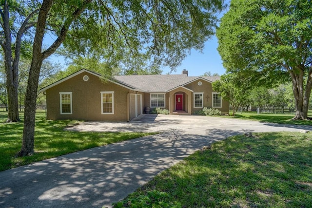 ranch-style house featuring a chimney, a front lawn, stucco siding, an attached garage, and concrete driveway