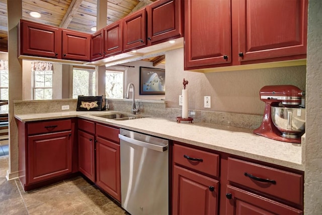 kitchen featuring a peninsula, beam ceiling, a sink, wood ceiling, and dishwasher