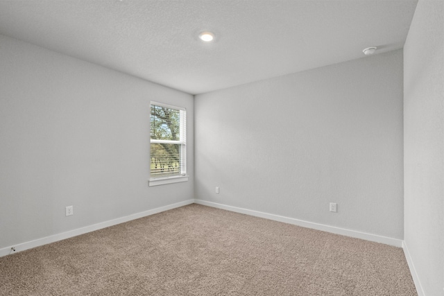 2705 Sage Ranch Dr Unit 30, Leander, TX 78641 - spare room featuring light carpet, baseboards, and a smoke detector