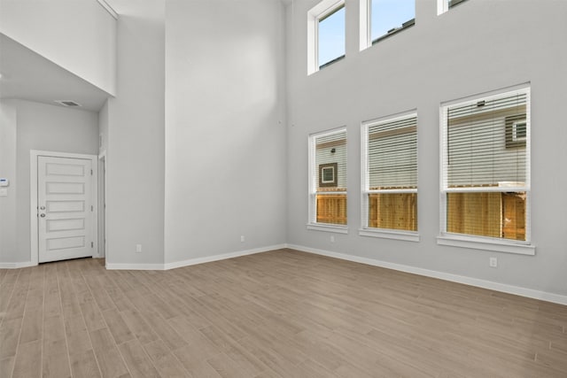2705 Sage Ranch Dr Unit 30, Leander, TX 78641 - unfurnished room with a towering ceiling, baseboards, and light wood finished floors