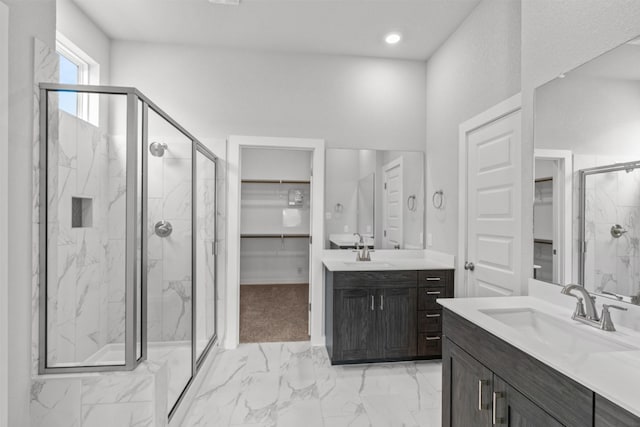 2705 Sage Ranch Dr Unit 30, Leander, TX 78641 - bathroom featuring a spacious closet, a marble finish shower, two vanities, and marble look tile flooring