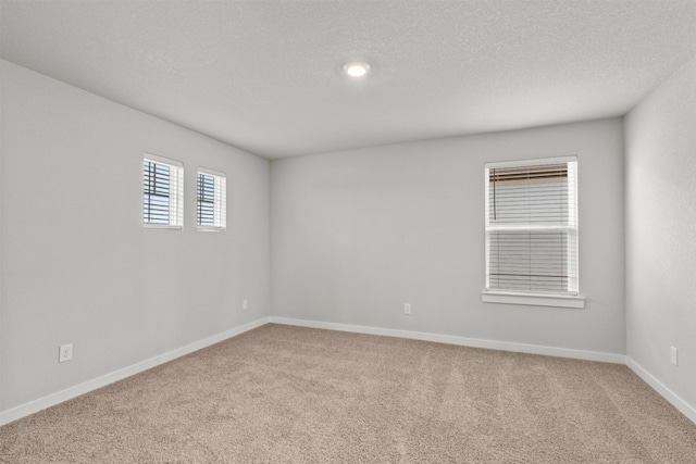 2705 Sage Ranch Dr Unit 30, Leander, TX 78641 - unfurnished room featuring carpet flooring, baseboards, and a textured ceiling