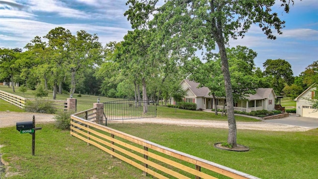 exterior space with driveway, fence, and a yard
