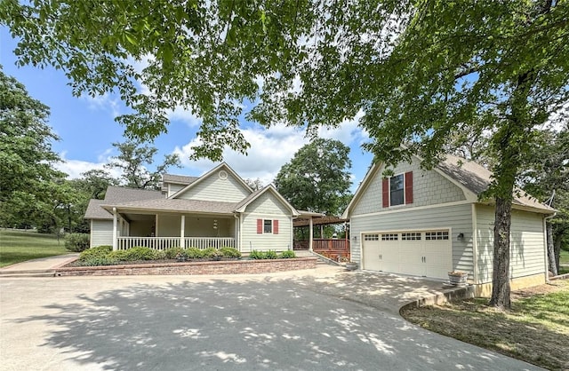 craftsman house featuring a garage, concrete driveway, and covered porch