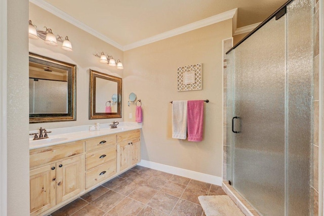 bathroom with a sink, double vanity, baseboards, a shower stall, and crown molding