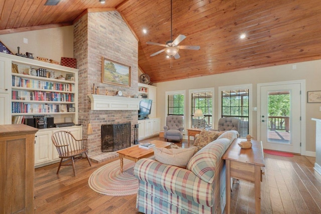 living area featuring high vaulted ceiling, hardwood / wood-style flooring, a healthy amount of sunlight, and wooden ceiling