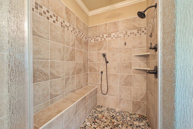 full bathroom with crown molding and tiled shower