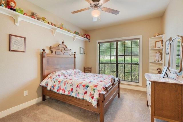 bedroom with ceiling fan, baseboards, and light carpet