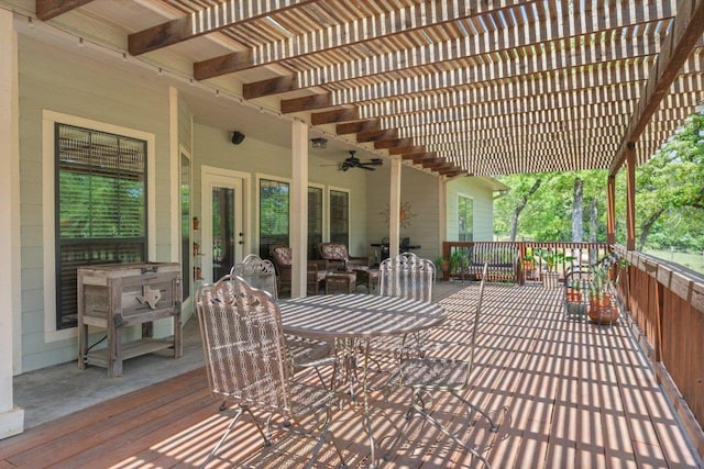deck featuring a pergola, a ceiling fan, and outdoor dining space