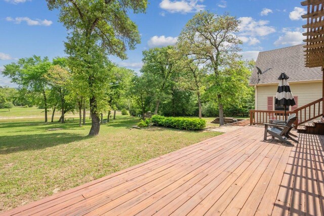 wooden terrace with a lawn
