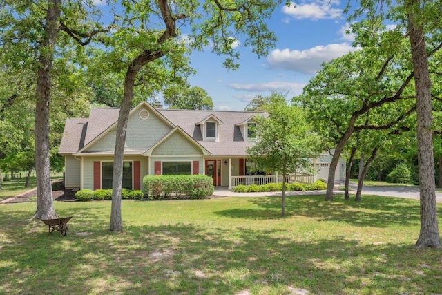 cape cod home featuring a chimney, a front lawn, driveway, covered porch, and a garage