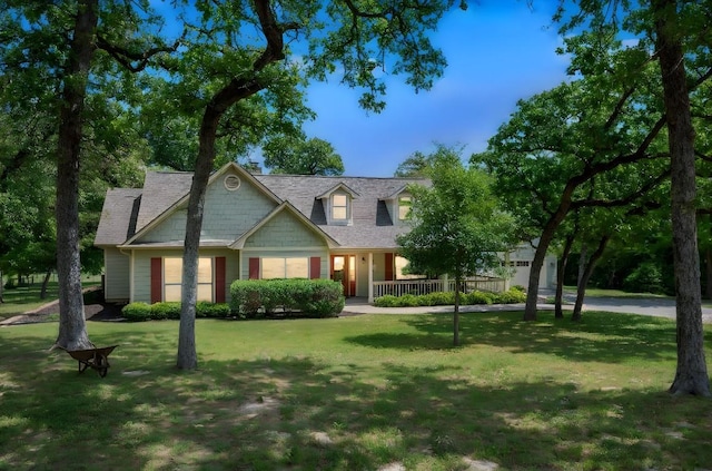view of front of home with a front lawn, covered porch, and a garage