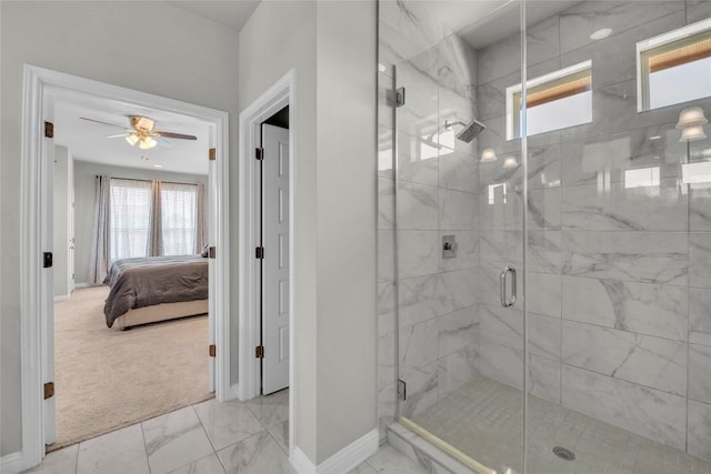 ensuite bathroom with baseboards, marble finish floor, and a wealth of natural light