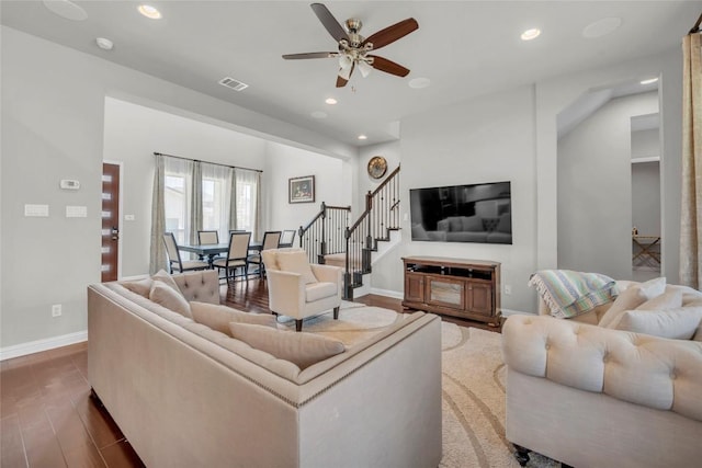 living room featuring recessed lighting, visible vents, and stairs