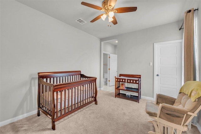 carpeted bedroom with baseboards, a ceiling fan, and visible vents