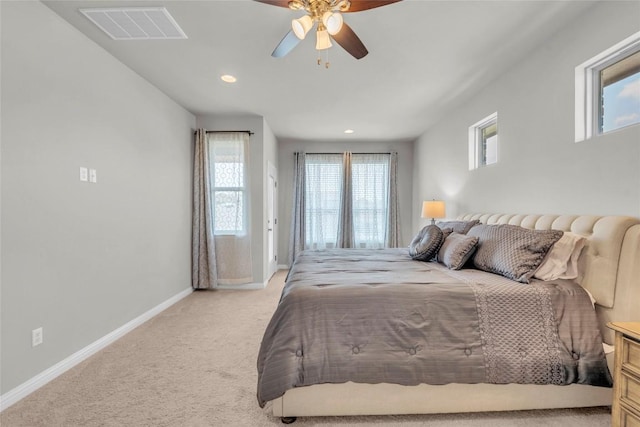 bedroom featuring a ceiling fan, light colored carpet, baseboards, visible vents, and recessed lighting