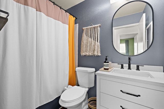 full bathroom with toilet, vanity, and curtained shower