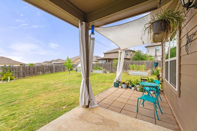 view of patio / terrace featuring a fenced backyard and a residential view