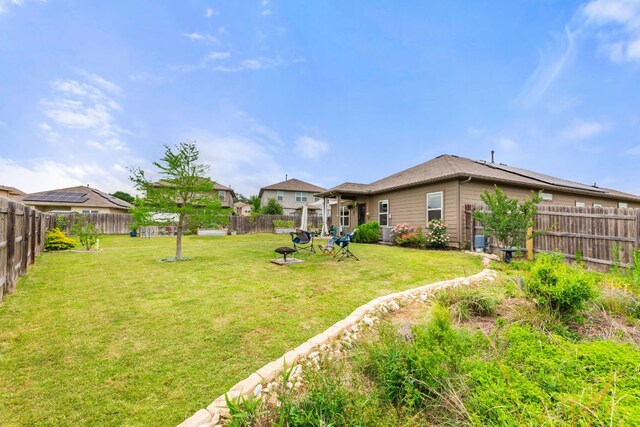 view of yard featuring a fire pit and a fenced backyard