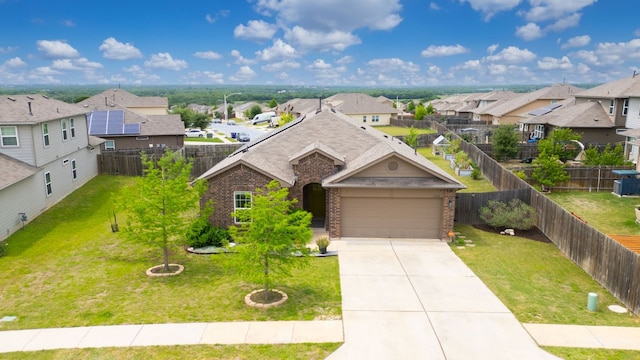 view of front of home featuring brick siding, a residential view, driveway, a front lawn, and an attached garage