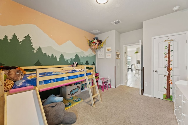 carpeted bedroom featuring baseboards and visible vents