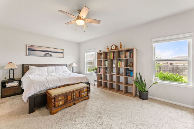 carpeted bedroom featuring ceiling fan and baseboards