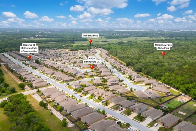 birds eye view of property with a residential view and a view of trees