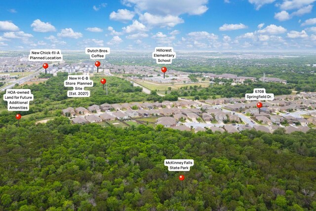 drone / aerial view featuring a wooded view