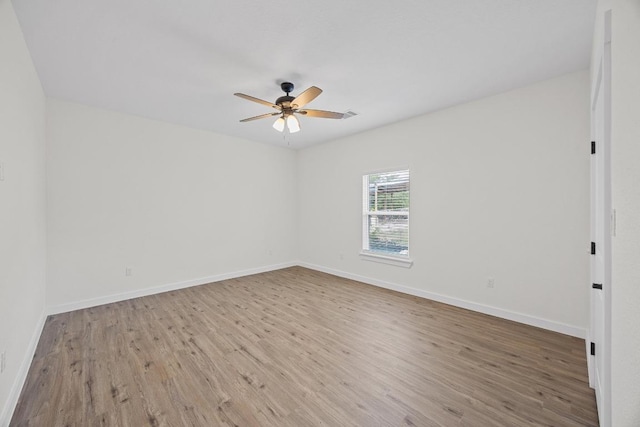 17701 Village Dr, Dripping Springs, TX 78620 - spare room with wood finished floors, a ceiling fan, and baseboards