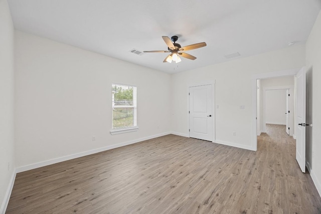 17701 Village Dr, Dripping Springs, TX 78620 - unfurnished bedroom with light wood-style floors, baseboards, and ceiling fan