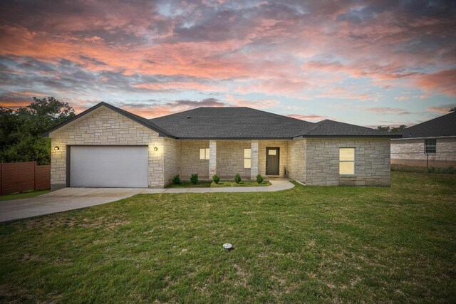 17701 Village Dr, Dripping Springs, TX 78620 - view of front facade featuring driveway, a garage, stone siding, and roof with shingles