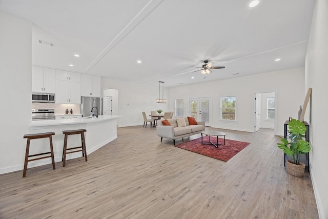 17701 Village Dr, Dripping Springs, TX 78620 - living area with ceiling fan, light wood finished floors, recessed lighting, and baseboards