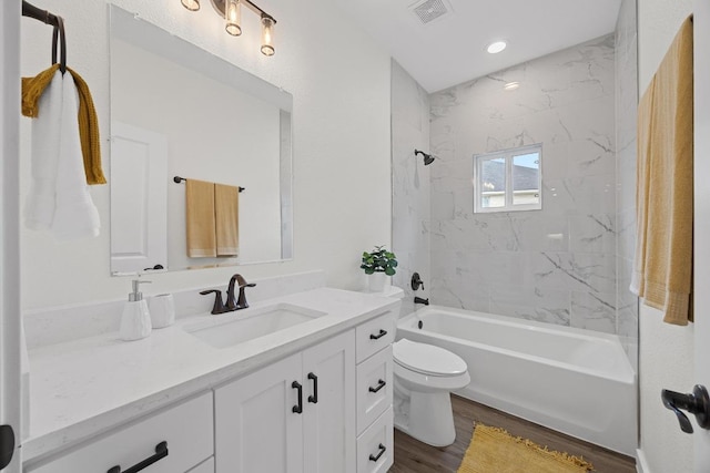 17701 Village Dr, Dripping Springs, TX 78620 - bathroom with vanity, wood finished floors, toilet, and shower / washtub combination