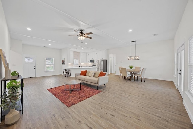 17701 Village Dr, Dripping Springs, TX 78620 - living room featuring light wood-type flooring, a ceiling fan, recessed lighting, and baseboards